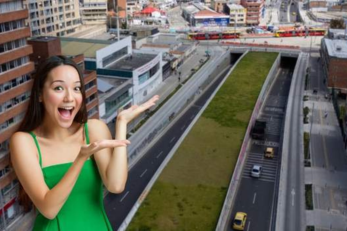 Mujer sonriente en primer plano con vestido verde y brazos abiertos; al fondo, vista aérea de avenida urbana con túneles, césped central, autos circulando y edificios a los lados.